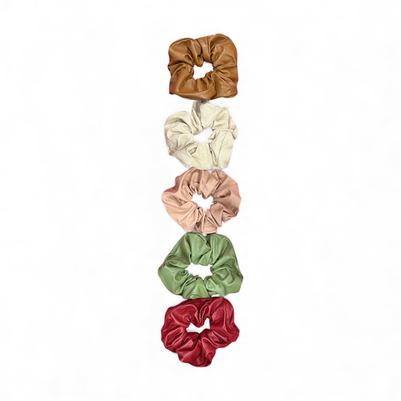 Set of five colorful scrunchies stacked on a white background