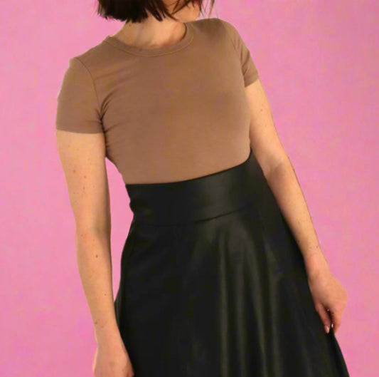 woman with brown tee and black high waisted skirt