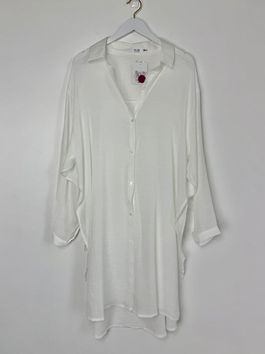 White shirt on a hanger against a white background