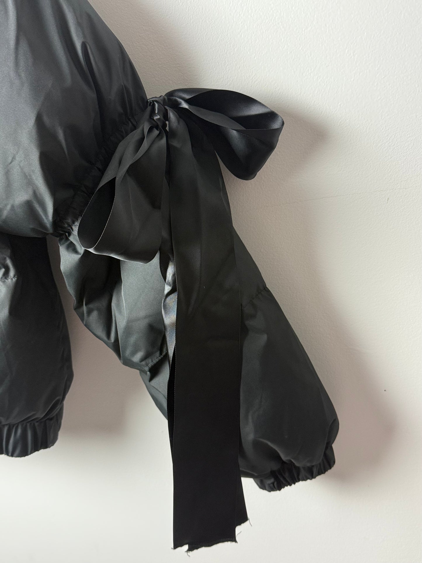 Midnight Ribbon Puffer Jacket – Feminine, Warm & Boldly Styled