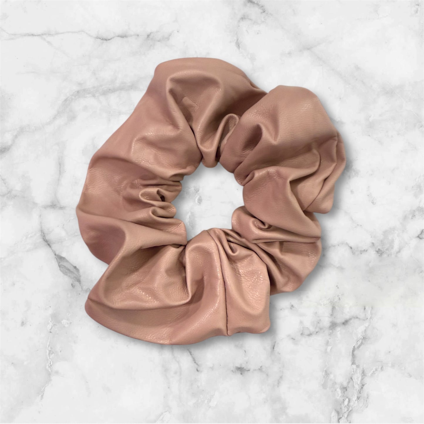 Pink pleather scrunchie on a marble background