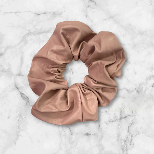 Pink pleather scrunchie on a marble background