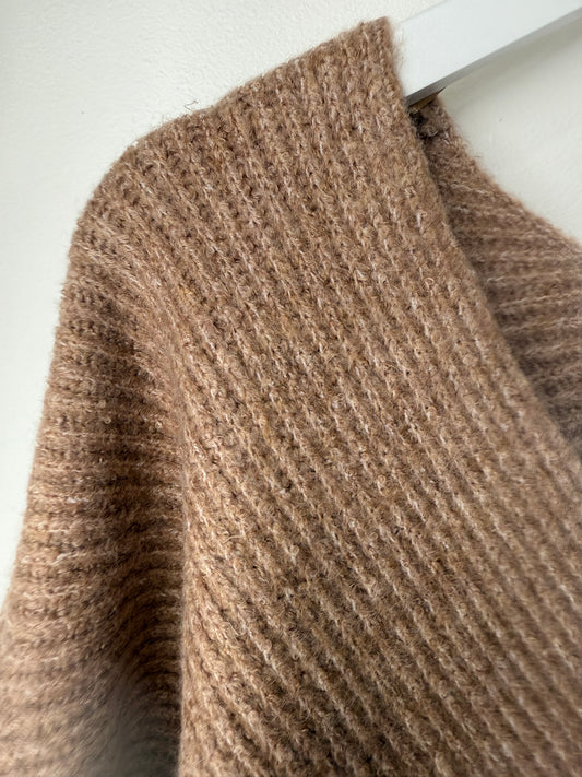 Close-up of a brown textured rug on a white floor