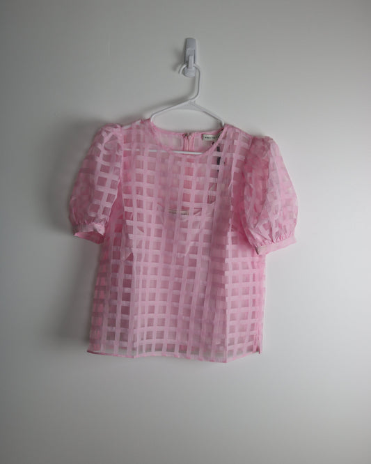 A pink plaid print sheer top with puff sleeves, displayed on a hanger against a white background.