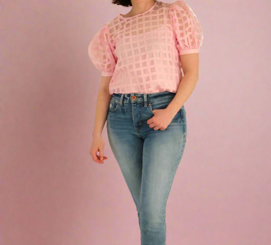 Sheer puff sleeve top on woman wearing jeans