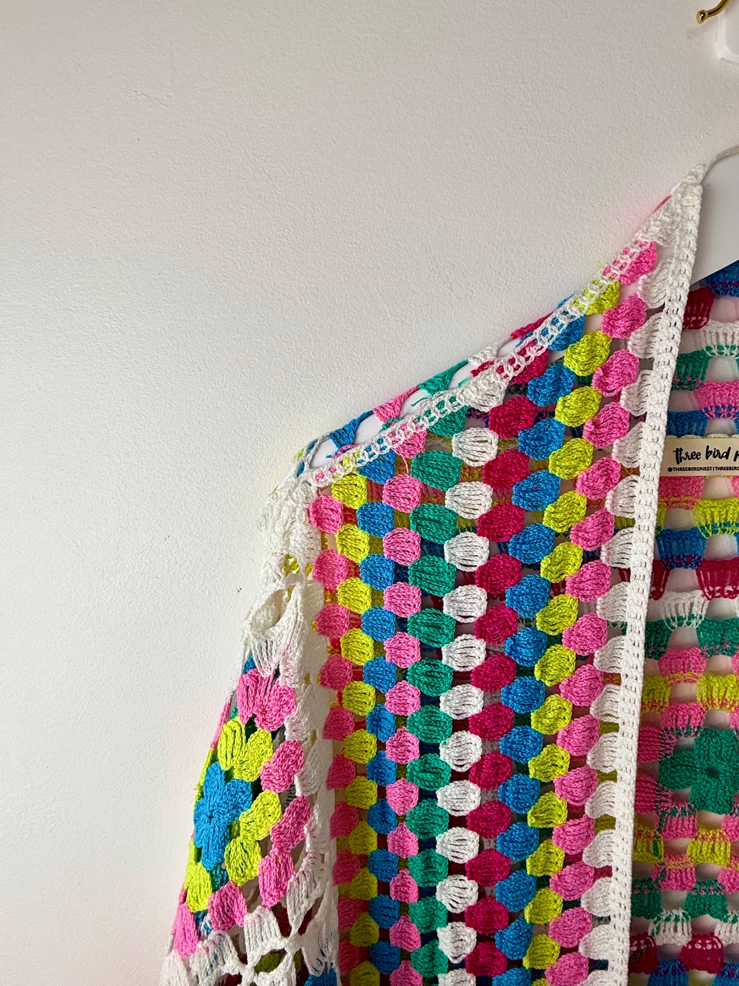 Colorful crocheted garment on a white background