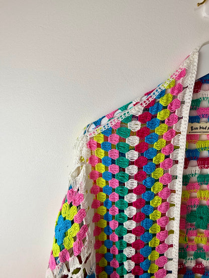 Colorful crocheted garment on a white background