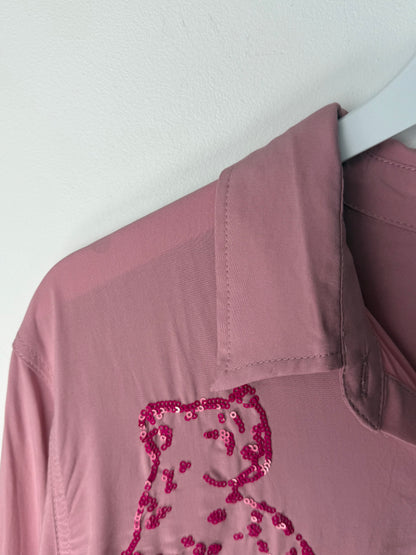 Pink button up with a sequined design on a white background