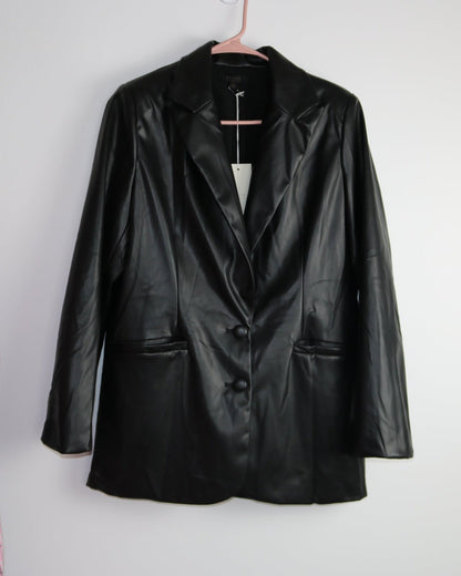 A faux leather blazer hanging on a hanger against a white background.