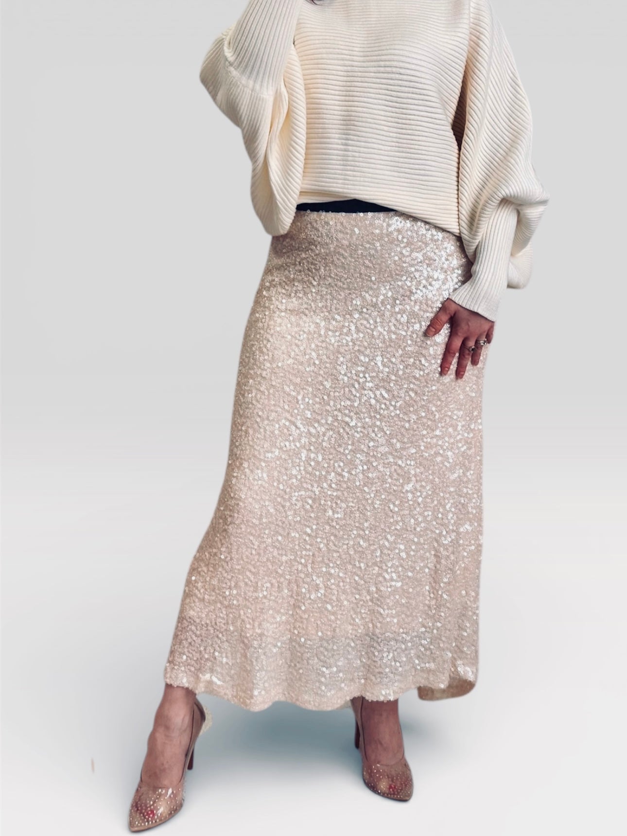 Women wearing ivory dolman sweater with ivory sequin maxi skirt