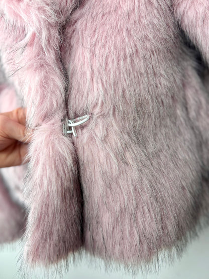 Close-up of pink fur with a metal clasp on a white background