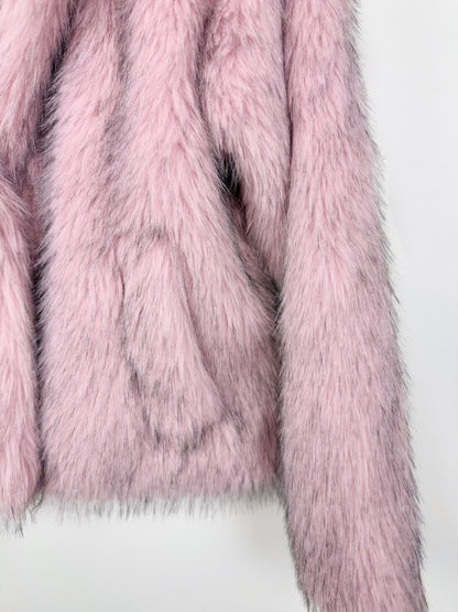 Close-up of a pink faux fur coat on a white background