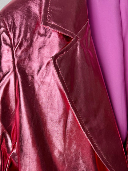 Close-up of a shiny metallic pink women’s leather jacket with a blurred pink background
