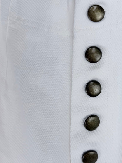 Close-up of white jeans with dark buttons on a white background