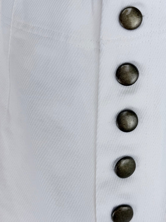 Close-up of white jeans with dark buttons on a white background