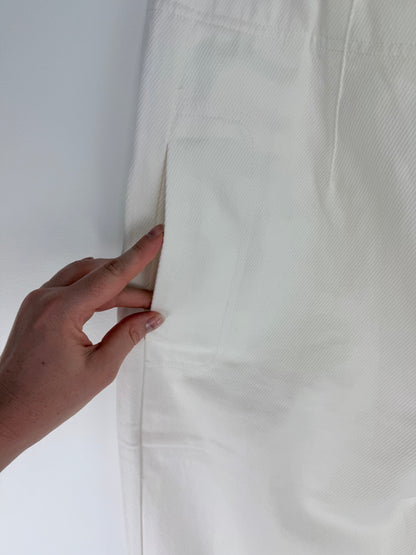 Close-up of a hand touching a white fabric surface