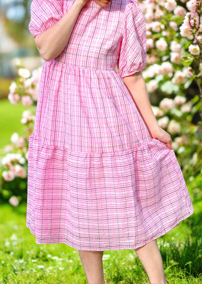 Woman in pink dress with field background 